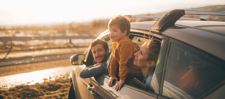 family enjoying a road trip in their car