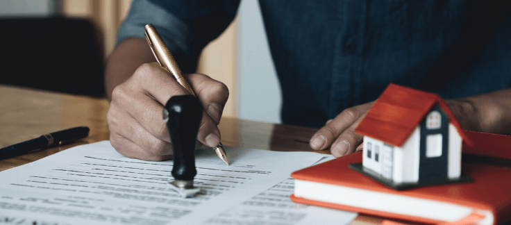 Man signing a home loan document