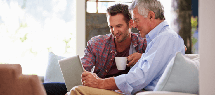 father and son sitting in lounge looking at saving for deposit