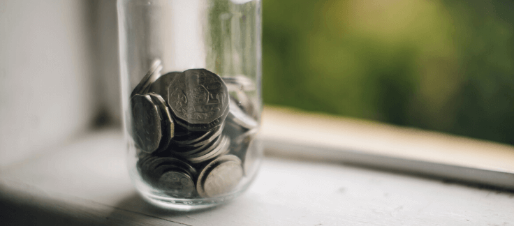 A jar with coins on the window sill