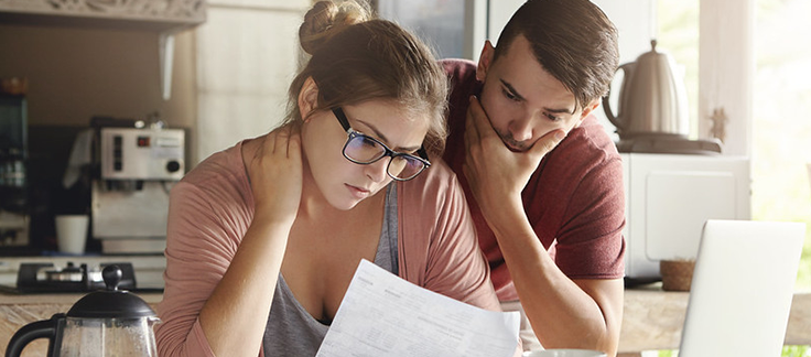 stressed couple looking at documents